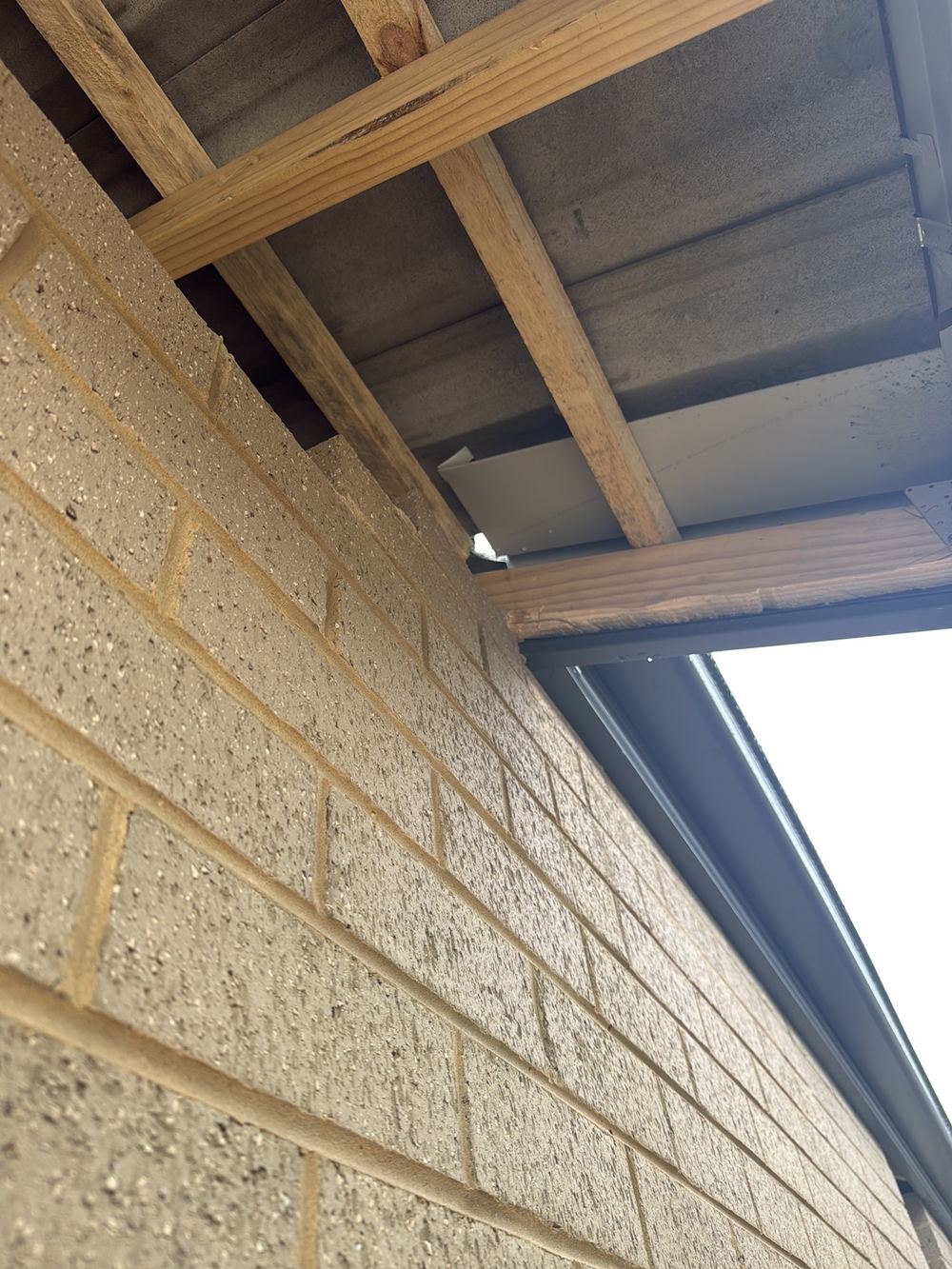 Roof junction left without flashing, so rain can reach the wall cavity, found during a fixing stage inspection in Clyde North