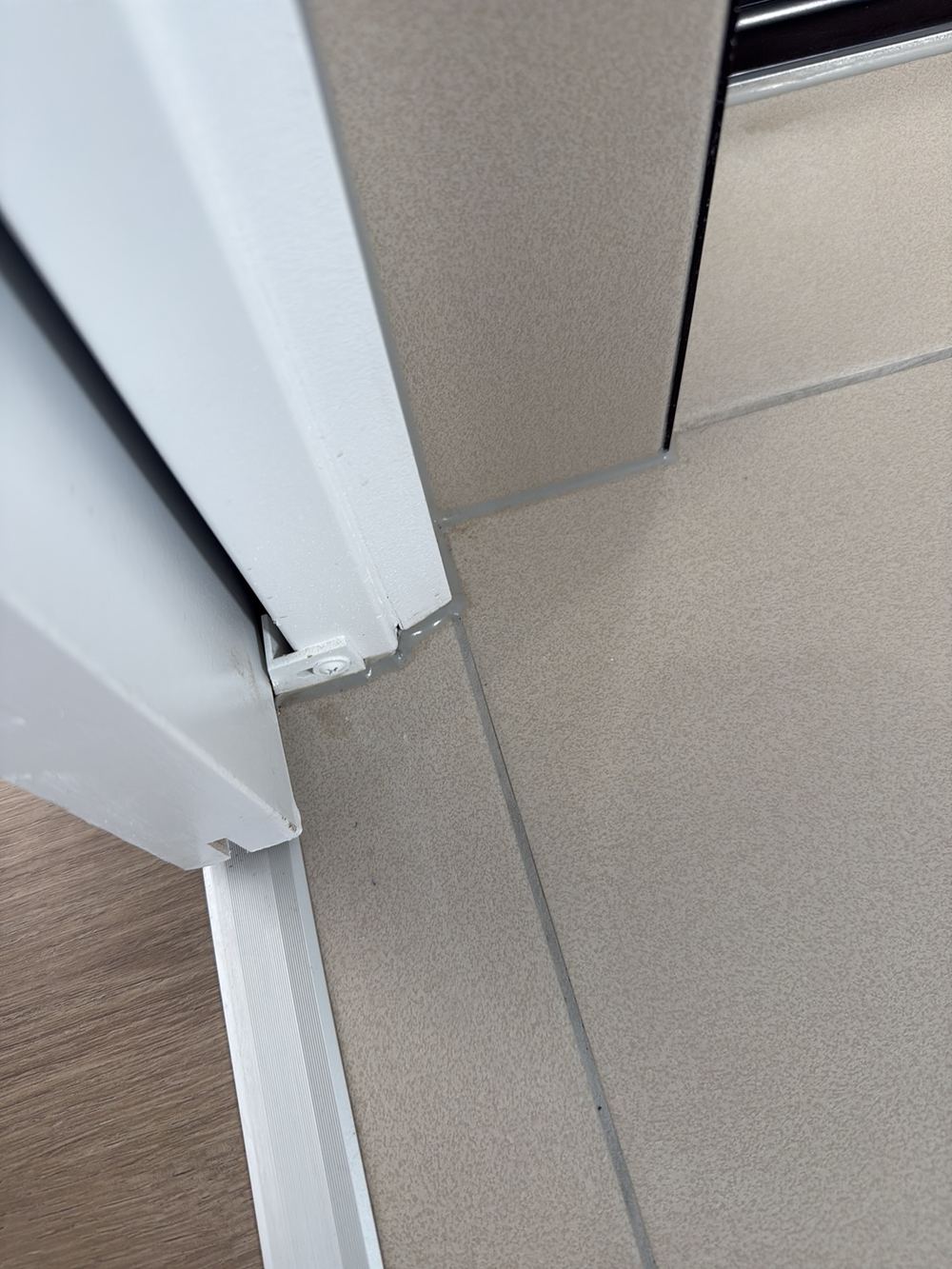 Water stop angle broken at the door jambs where the membrane should continue, found during a pre-handover inspection in Clyde North