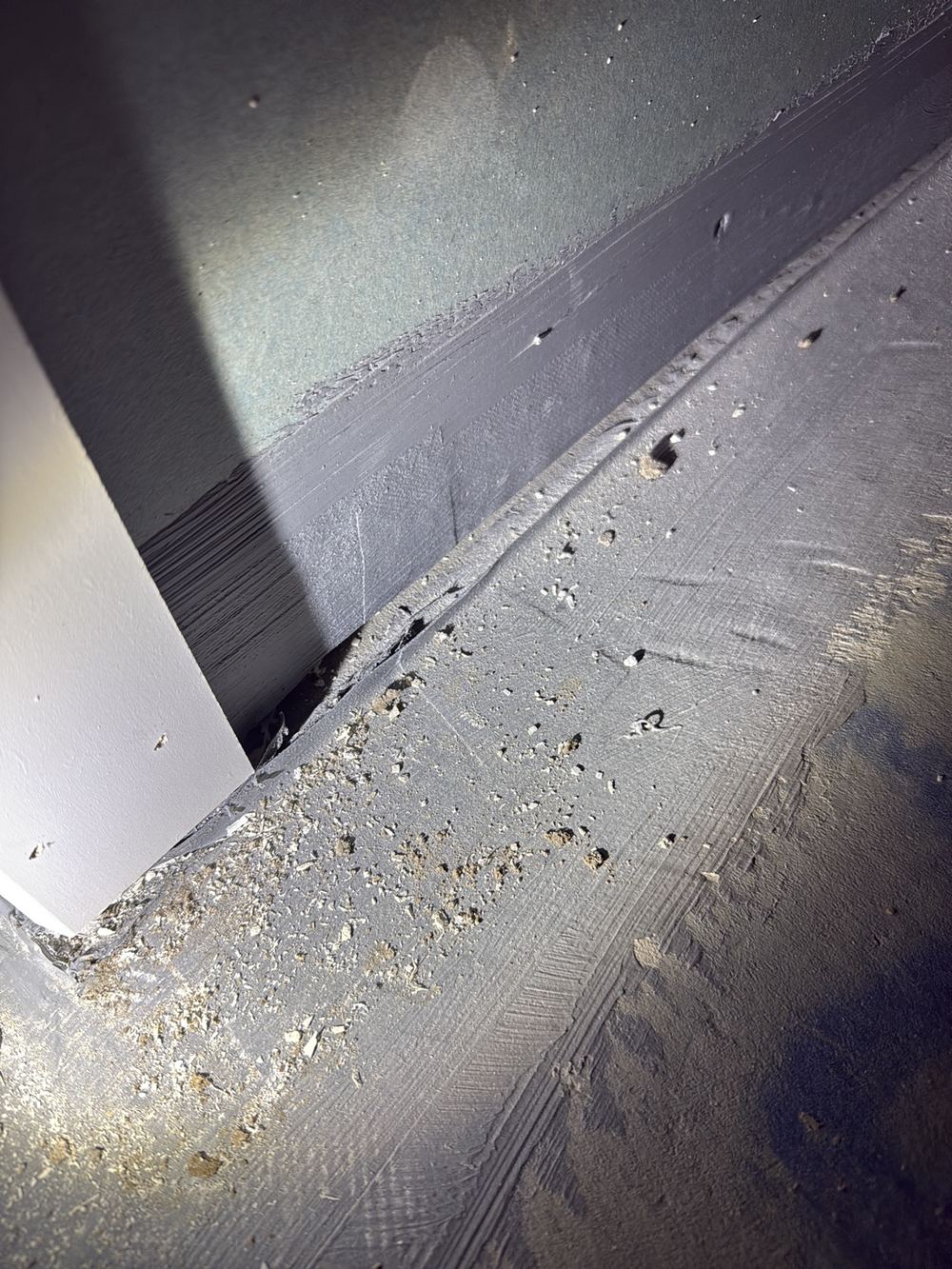 Membrane split at the wall junction, breaking the continuity of the seal, found during a waterproofing inspection in Clyde North
